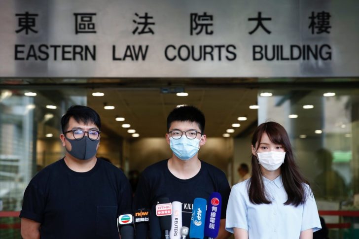 Pro-democracy activists Ivan Lam, Joshua Wong and Agnes Chow arrive to the Eastern Court for hearing in Hong Kong