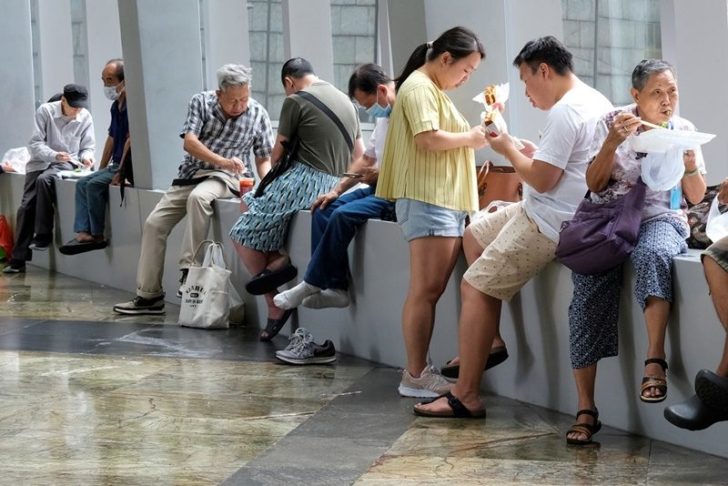 People have lunch at a mall after the government banned dine-in services, following the coronavirus disease (COVID-19) outbreak in Hong Kong