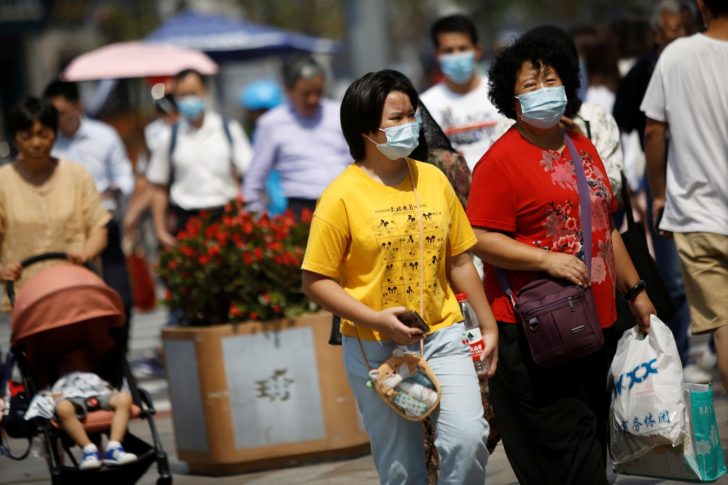 People are seen after Beijing announced that wearing face masks are no longer mandatory outdoor in Beijing, following the coronavirus disease (COVID-19) outbreak