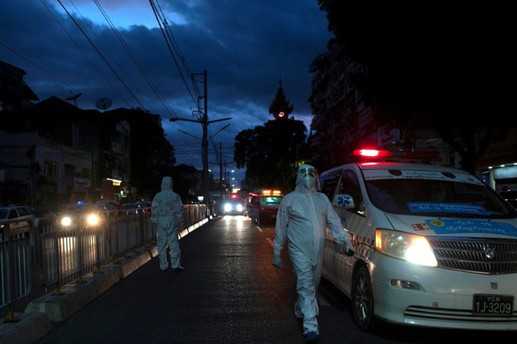 Medical staff wearing protective suits stand near an ambulance as they transfer suspect cases to a quarantine centers amid the outbreak of the coronavirus disease (COVID-19), in Yangon
