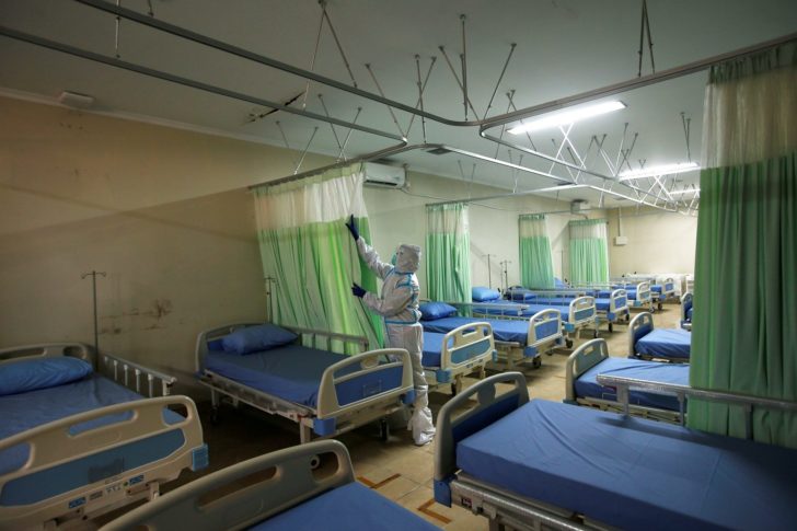 A medical worker wearing a protective suit is pictured inside a room at Patriot Candrabhaga Stadium, which is prepared for a coronavirus disease (COVID-19) isolation facility, as an outbreak of the disease continues in Bekasi