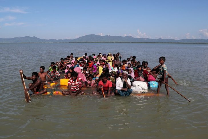 FILE PHOTO: Rohingya refugees cross the Naf River with an improvised raft to reach Bangladesh at Sabrang near Teknaf