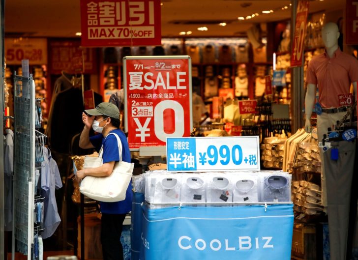 FILE PHOTO: A shopper wearing a protective face mask is seen at a shop selling office wear, amid the coronavirus disease (COVID-19) outbreak in Tokyo