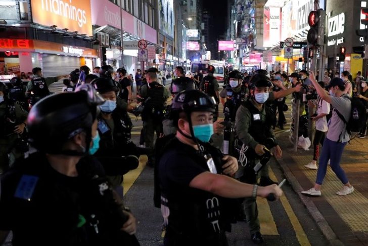Riot police disperse pro-democracy protesters during a demonstration opposing postponed elections, in Hong Kong