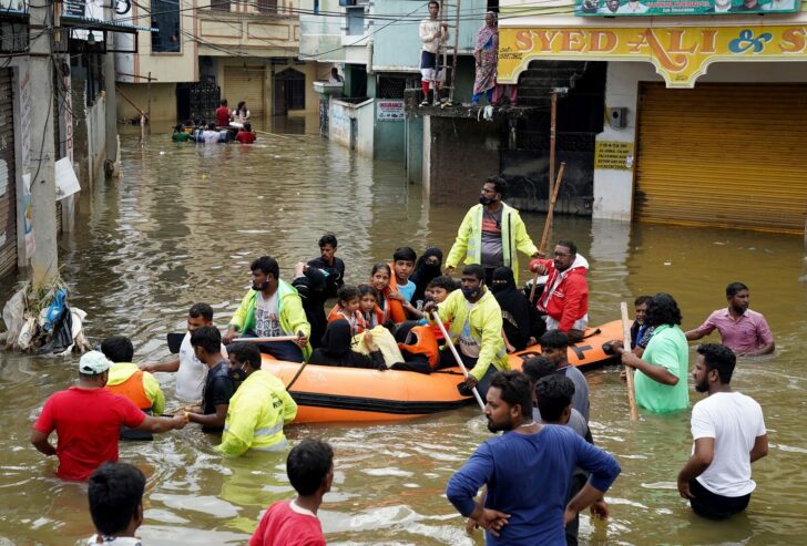 Residents are evacuated from a flooded neighbourhood after heavy rainfall in Hyderabad