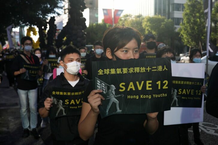 Protesters holding placards attend a rally calling China to release 12 Hong Kong people arrested at sea by mainland authorities, in Taipei