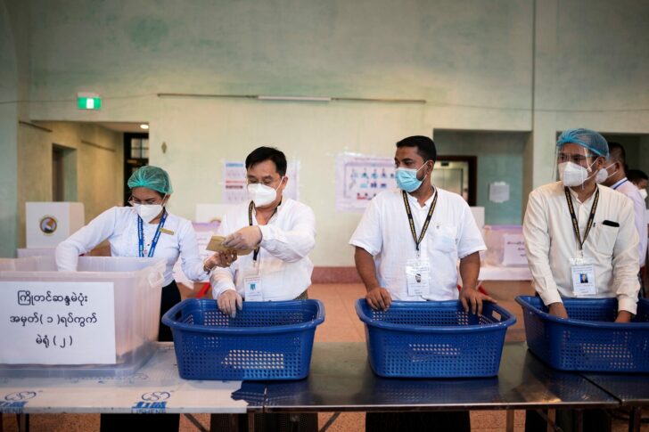 FILE PHOTO: Electoral workers start to count votes inside a polling station during the general election in Yangon