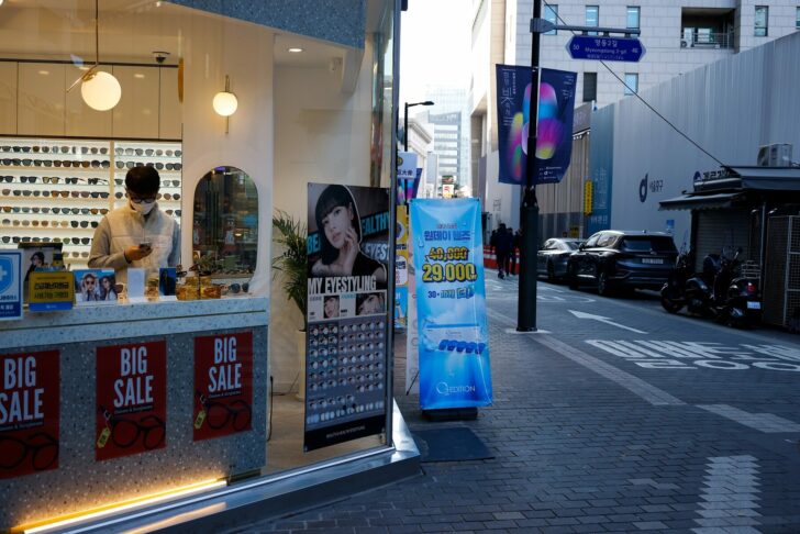 A shopkeeper waits for customers at an empty shopping district amid the coronavirus disease (COVID-19) pandemic in Seoul