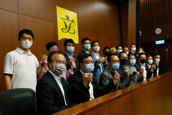 Pan-democratic legislators including Alvin Yeung, Dennis Kwok and Wu Chi-wai join their hands during a news conference as they threat with mass resignations amid reports on Beijing plans to disqualify four opposition lawmakers, in Hong Kong