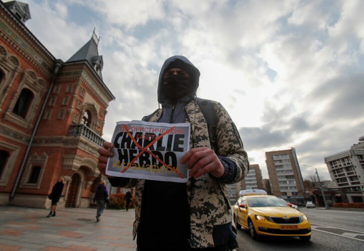 A participant holds a placard during a protest against the French satirical weekly newspaper Charlie Hebdo in Moscow