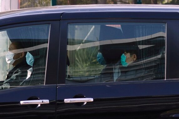 One of the 12 Hong Kong activists detained in mainland China over an illegal border crossing is seen in a vehicle after a transfer conducted at the China-Hong Kong border of Shenzhen Bay Port , in Hong Kong