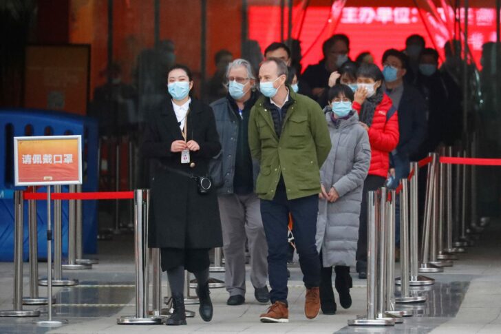 WHO team members leave an exhibition on how China fought the coronavirus in Wuhan