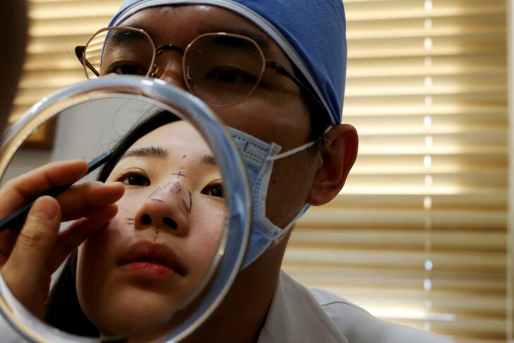 Ryu Han-na consults with Park Cheol-woo a director of WooAhIn Plastic Surgery Clinic before undergoing nose plastic surgery amid the coronavirus disease (COVID-19) pandemic in Seoul