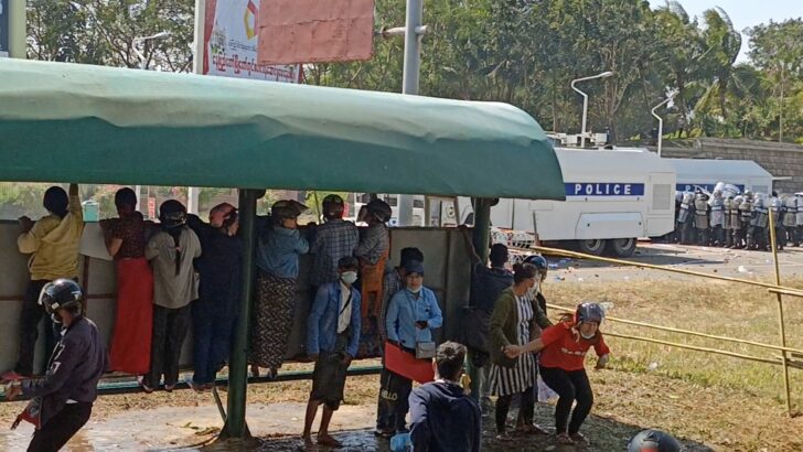 A woman drops on the ground injured by a gunshot wound in the head when police fired to clear protesters during a protest against the military coup in Naypyitaw