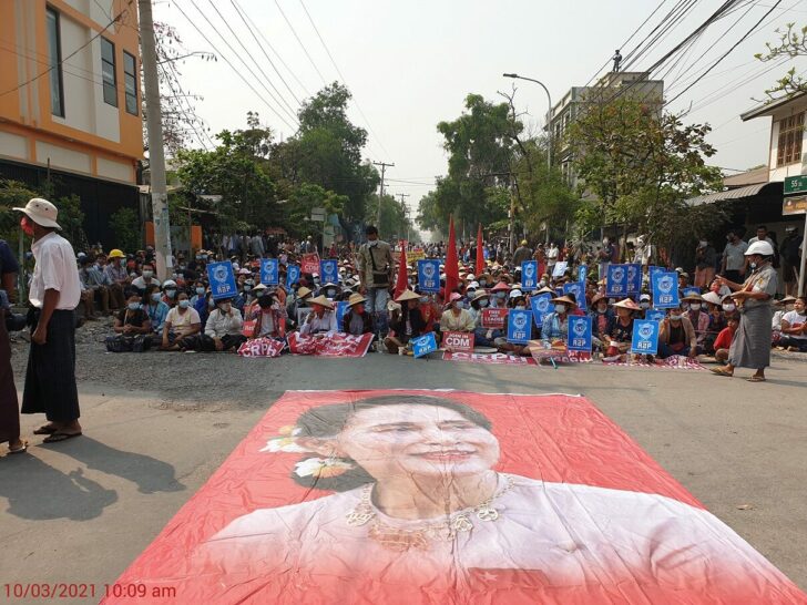 People take part in a sit-in protest in Mandalay