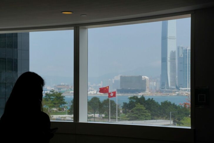 Chinese and Hong Kong flags are seen through a window outside the Legislative Council in Hong Kong