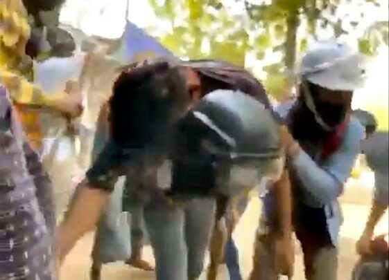 A man carries an injured protester shot during a protest against the military coup, in Monywa, Myanmar