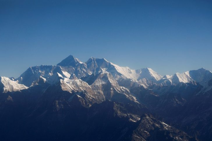 FILE PHOTO: FILE PHOTO: Mount Everest, the world highest peak, and other peaks of the Himalayan range are seen through an aircraft window during a mountain flight from Kathmandu