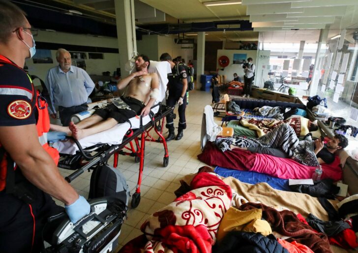 An asylum seeker is transported to a hospital by healthcare workers, in Brussels
