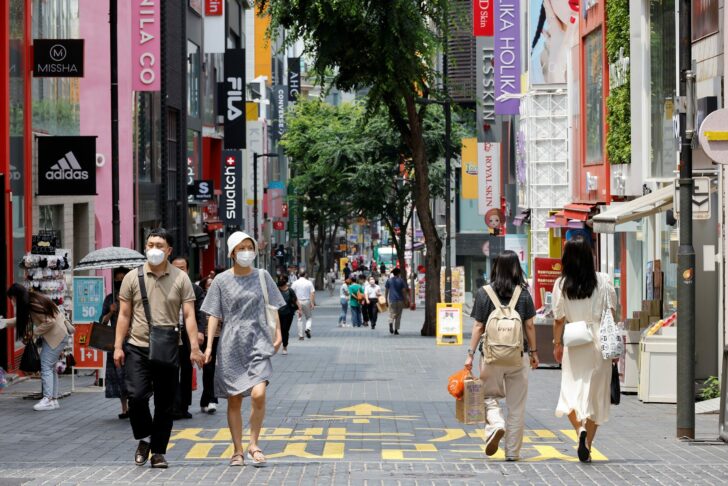 People wearing masks walk in a shopping district amid the coronavirus disease (COVID-19) pandemic in Seoul