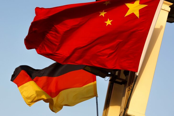 FILE PHOTO: German and Chinese national flags fly in Tiananmen Square ahead of the visit of German Chancellor Angela Merkel in Beijing