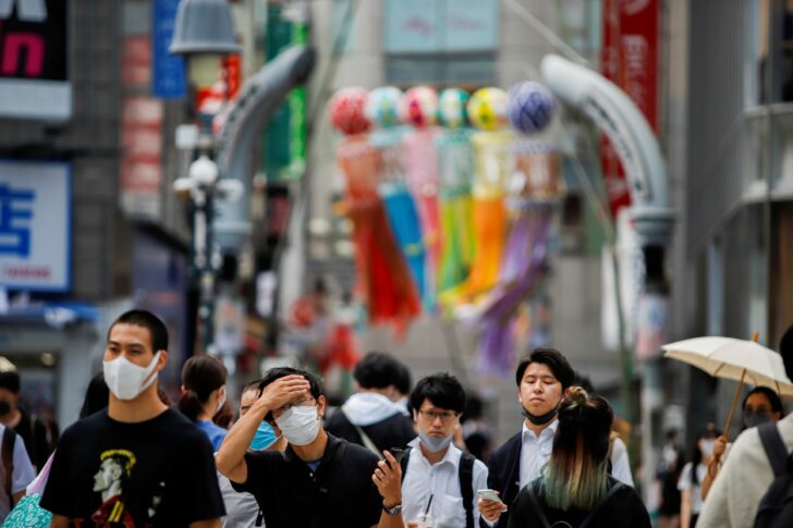People walk at the Shibuya crossing in Tokyo