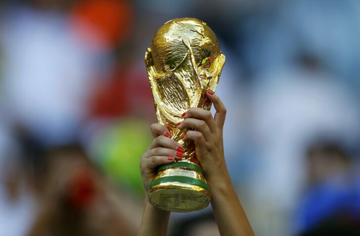 A fan holds up a trophy before the 2014 World Cup soccer match between England and Italy in Manaus