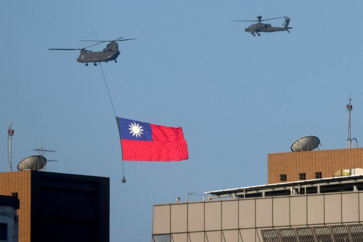 A Taiwan flag is carried across the sky during a national day rehearsal in Taipei