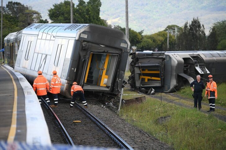 A derailed passenger train is seen after it hit a car on a level crossing in Kembla Grange