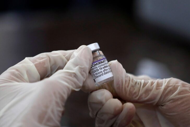 A health worker holds a vial of the