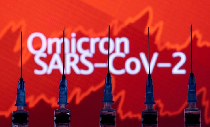 FILE PHOTO: yringes with needles are seen in front of a displayed stock graph and words