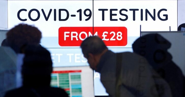 Customers are seen inside a private COVID-19 testing clinic in a busy shopping area, amid the coronavirus disease (COVID-19) outbreak in London