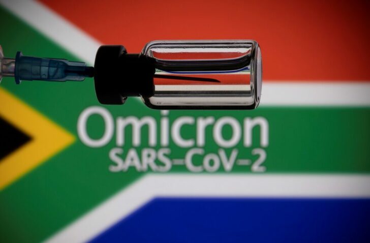 FILE PHOTO: A vial and a syringe are seen in front of a displayed South Africa flag and words