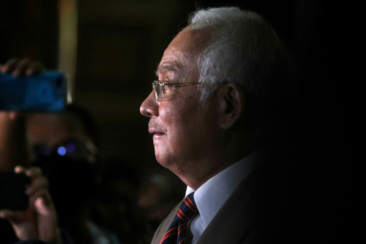 FILE PHOTO: Former Malaysian Prime Minister Najib Razak reacts during a news conference outside Kuala Lumpur High Court in Kuala Lumpur