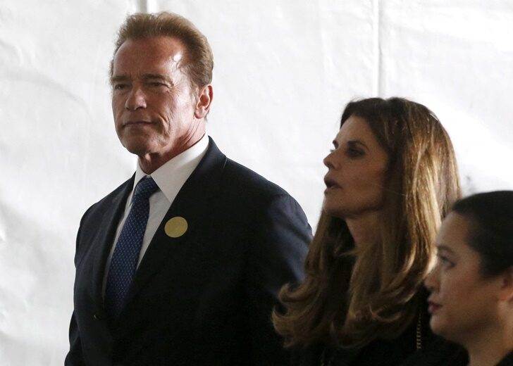 FILE PHOTO: Former California Governor Arnold Schwarzenegger and Maria Shriver walk to the grave site at the funeral of Nancy Reagan at the Ronald Reagan Presidential Library in Simi Valley, California