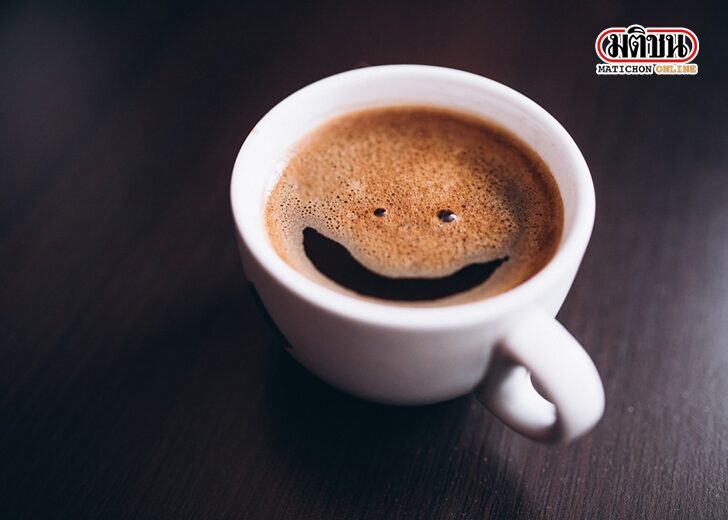 Cup of coffee with foam, smile face, on desk isolated