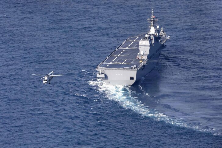 Japan's Maritime Self-Defence Force's vessel Hyuga and helicopter conduct search operations for missing F-15 fighter jet off Komatsu, Japan