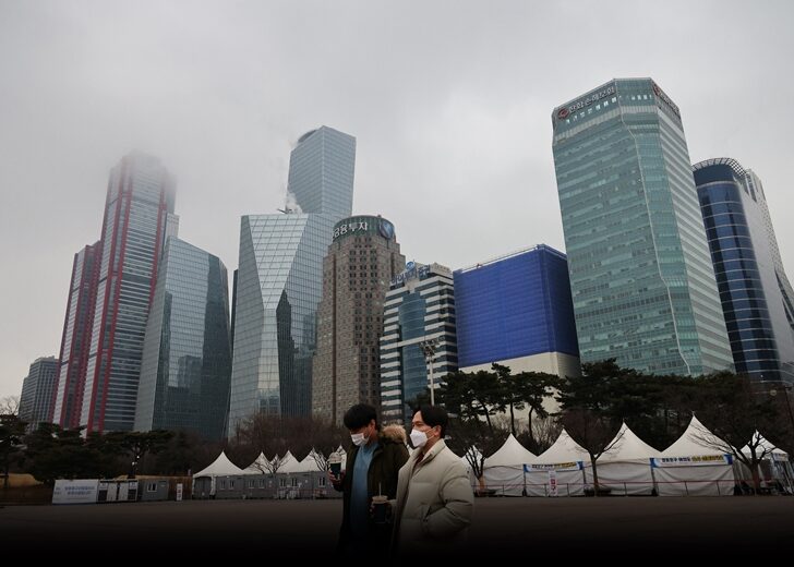 Men wearing masks to prevent contracting the coronavirus disease (COVID-19) walk at an empty park in Seoul