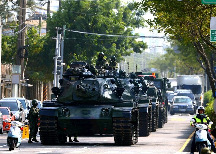 Soldiers drive M60 tanks on a street as part of a military drill in Taichung