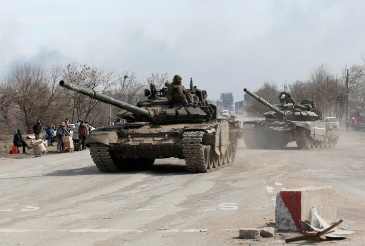 Service members of pro-Russian troops are seen in the besieged city of Mariupol