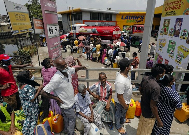 People queue to buy kerosene at a fuel station in Colombo