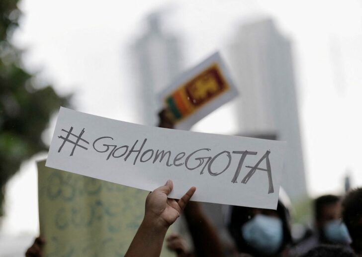 FILE PHOTO: A person holds a placard demanding Sri Lanka's President Rajapaksa to resign during a protest in Colombo