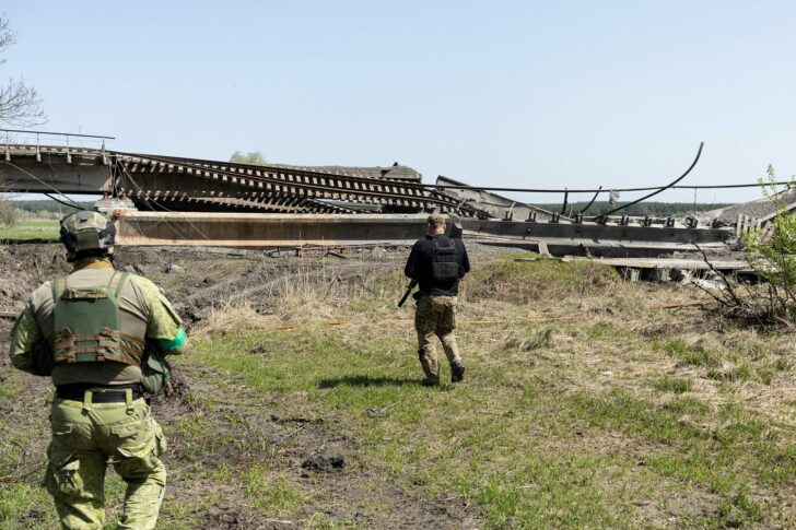 Ukrainian soldiers walks next to destroyed train line near Sviatohirsk, in Donetsk region