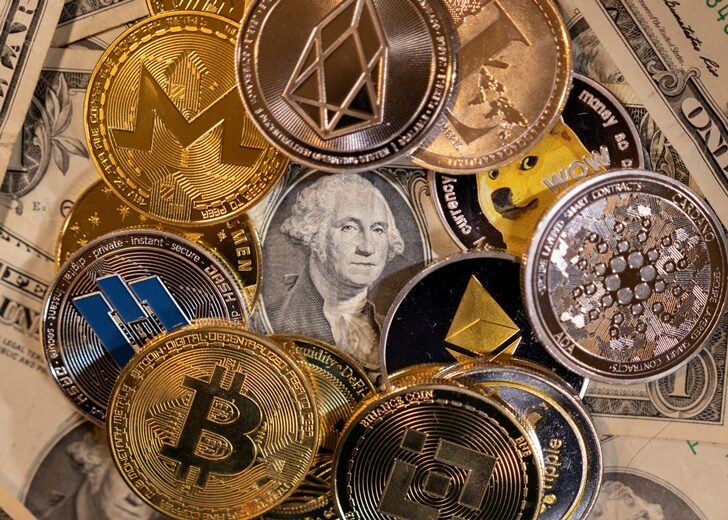 FILE PHOTO: Ilustration shows representations of virtual cryptocurrencies on U.S. dollar banknotes