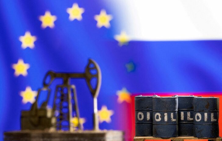 FILE PHOTO: Illustration shows models of oil barrels and a pump jack in front of U.S. and Russia flag colours