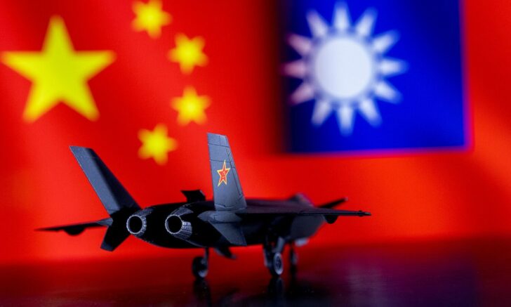 FILE PHOTO: Illustration shows model of Chinese Fighter in front of Chinese and Taiwanese flags