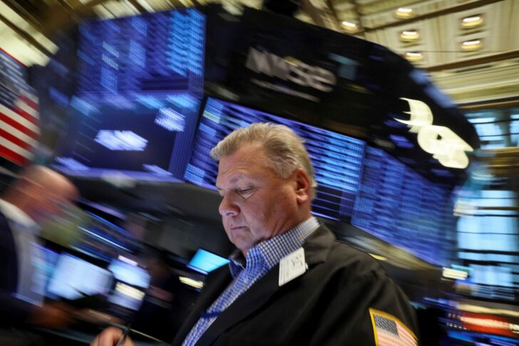 Traders work on the floor of the NYSE in New York
