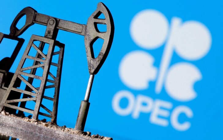 FILE PHOTO: A 3D printed oil pump jack in front of the OPEC logo
