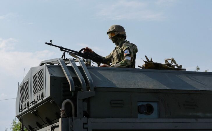 A Russian service member stands guard in Enerhodar