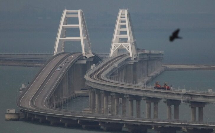Passenger cars drive on the Kerch bridge, after an explosion destroyed part of it, in the Kerch Strait, Crimea